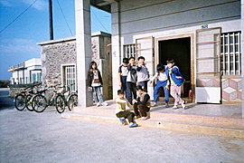 school kids chill off in the street